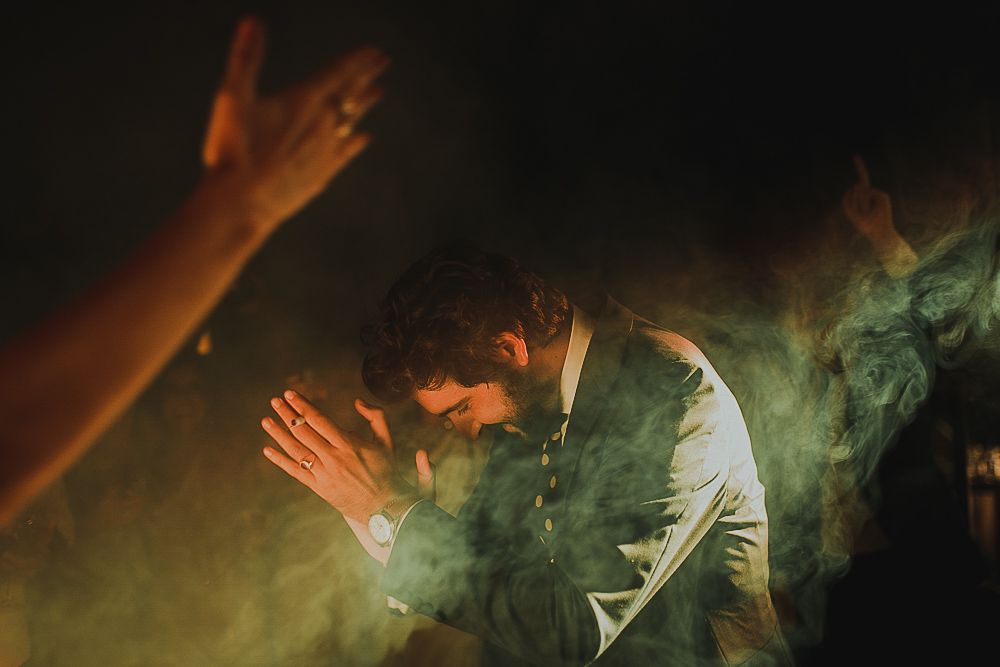 Atmospheric wedding dance scene with smoke effects and dramatic lighting.