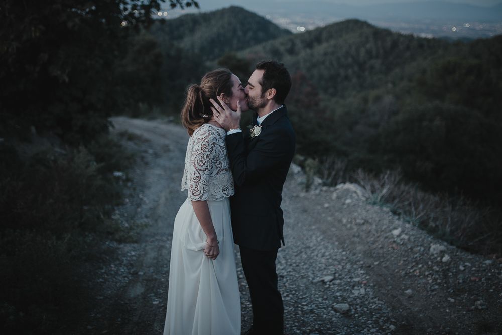 Romantic outdoor wedding portraits captured on a mountain trail at dusk.