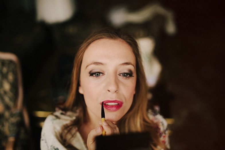 Close-up shot showing glamorous bridal makeup in dramatic lighting.