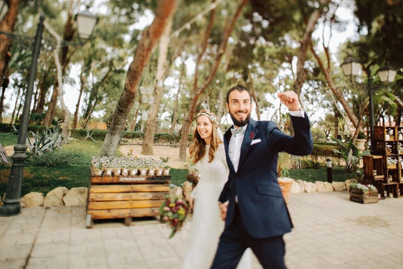 A joyful celebration moment captured in a wooded outdoor setting.