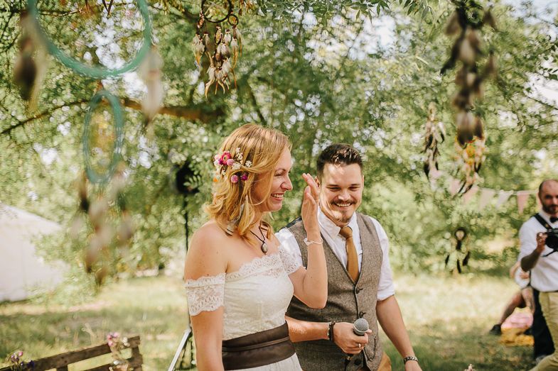 Joyful wedding moment during an intimate forest ceremony.