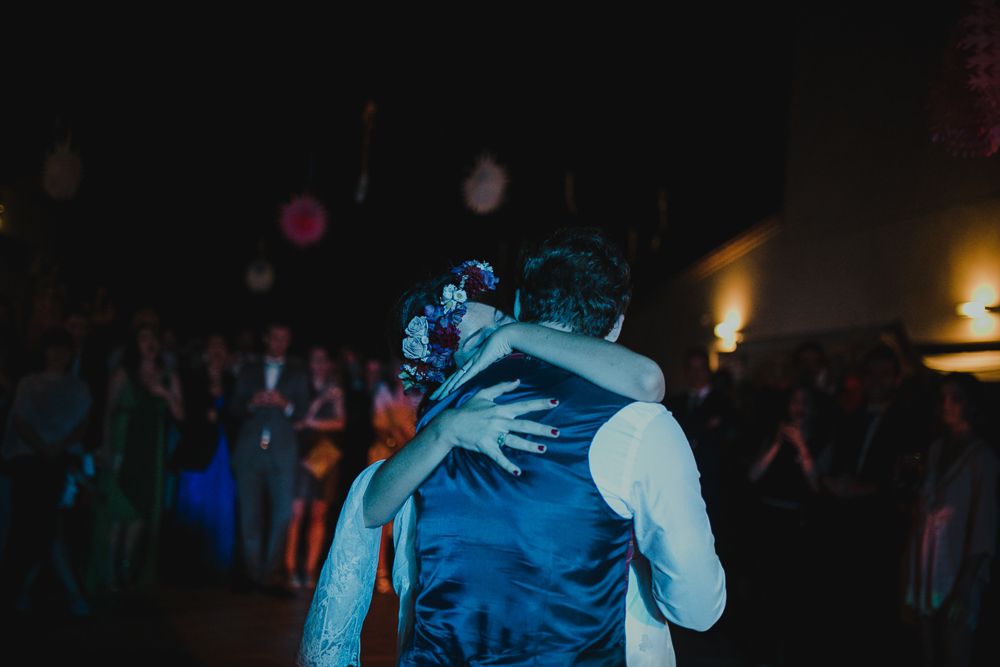 Dance floor moment captured in moody blue tones during an evening celebration.