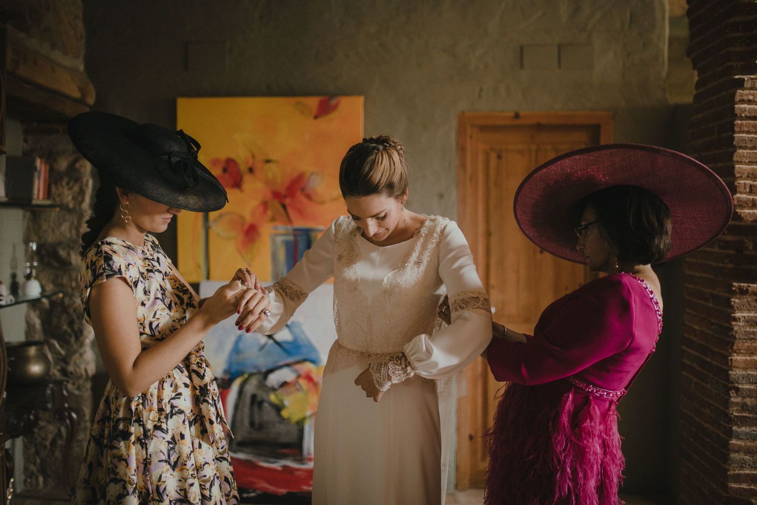 Wedding party members in elegant dresses gather during pre-ceremony preparations.