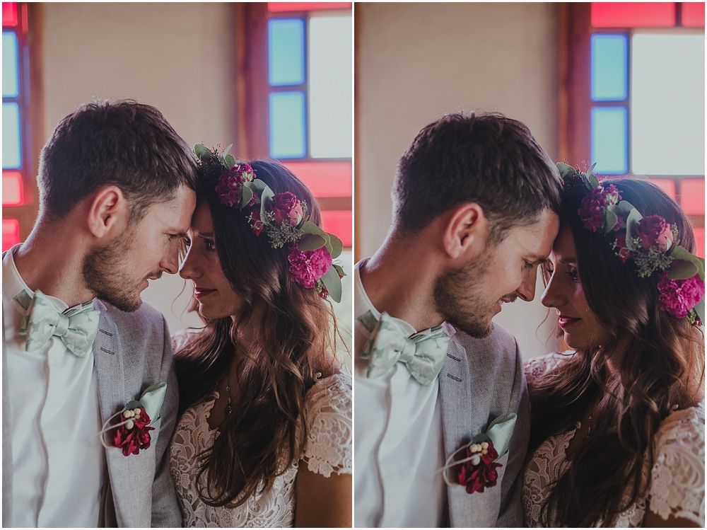 Intimate double portrait of newlyweds sharing tender moment with floral crown details.