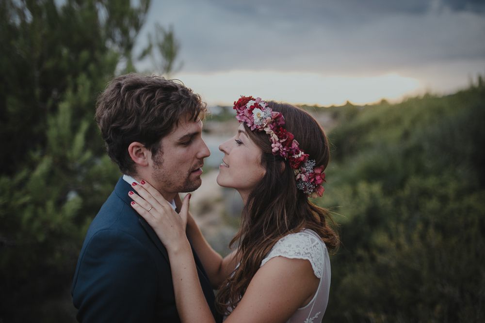 A romantic wedding portrait with the couple sharing an intimate moment at sunset.