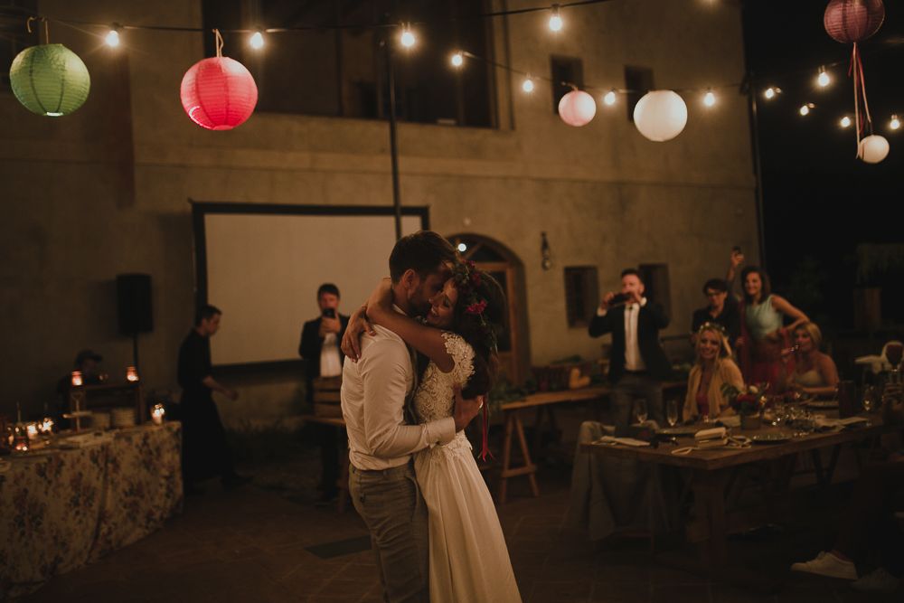 Wedding reception dance floor with string lights and colored lanterns creating an intimate ambiance.