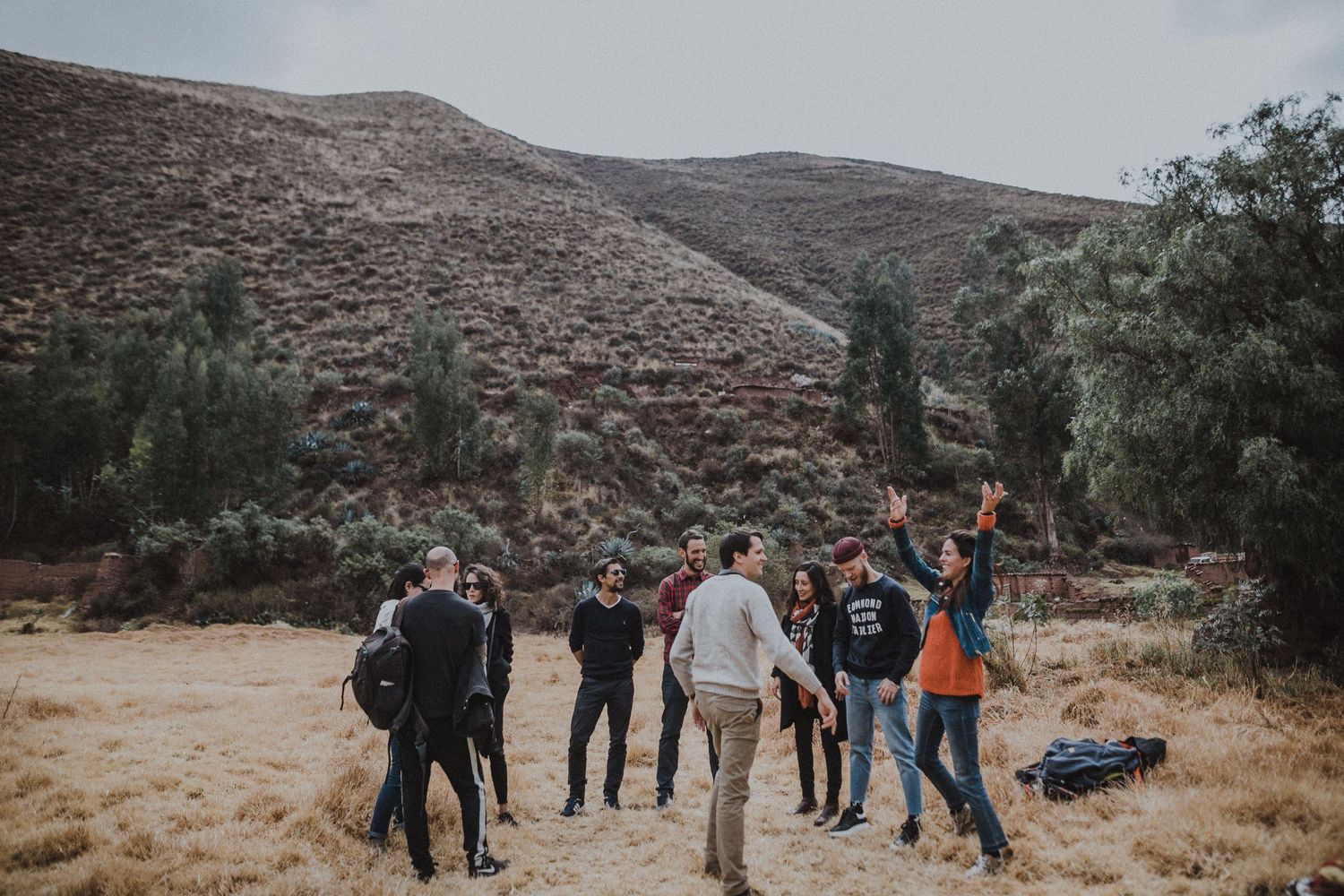 Group of hikers exploring a rugged mountain trail in an arid landscape.