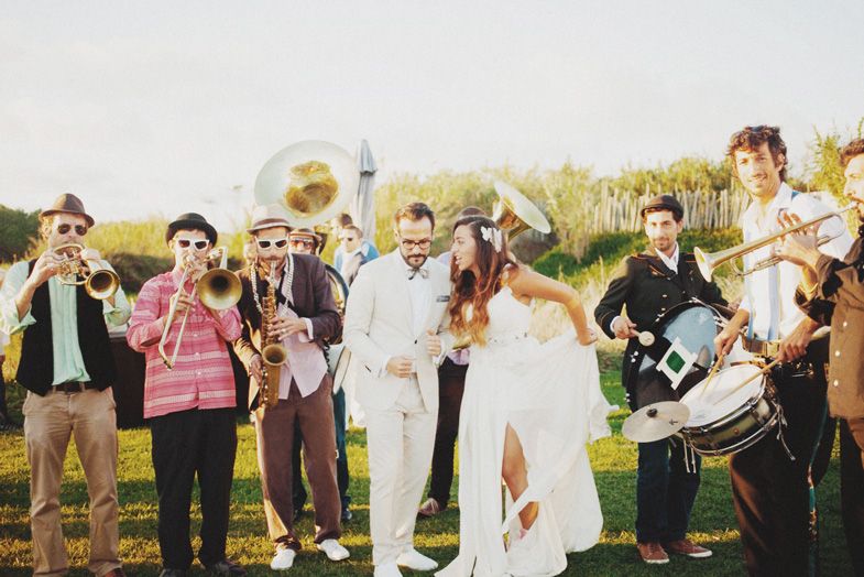 Wedding celebration with live band playing instruments outdoors.