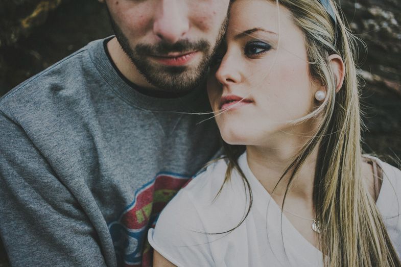A tender close-up portrait of a couple in casual attire.
