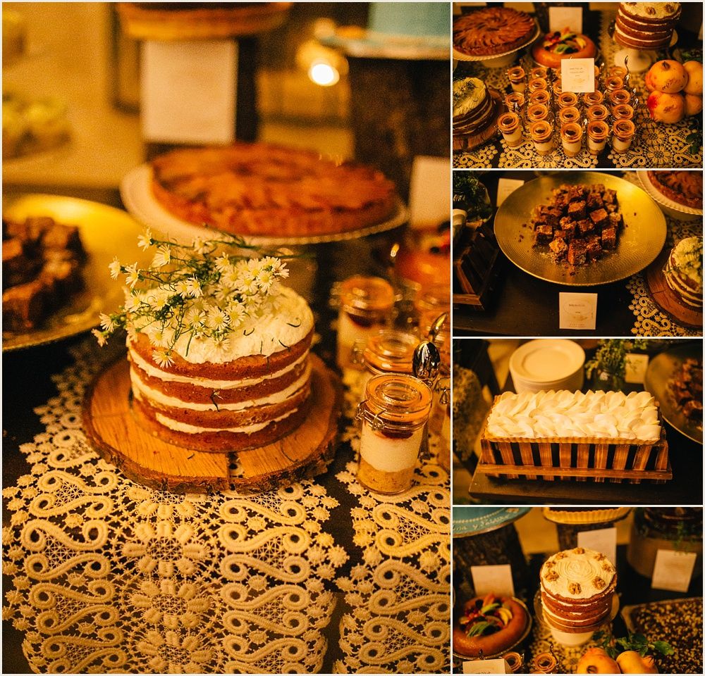 Rustic wedding dessert table with naked cakes and treats on lace tablecloth.