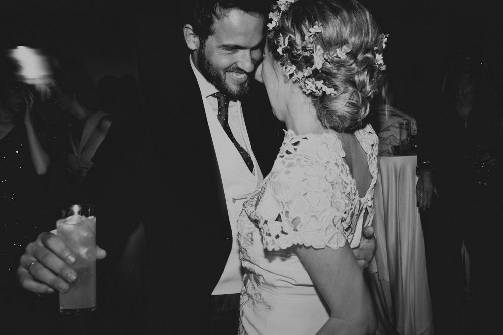 A romantic moment on the dance floor at an evening wedding reception.