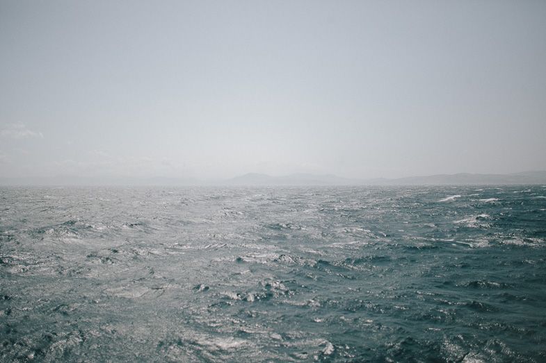 Dramatic seascape showing choppy waves on a stormy gray ocean.
