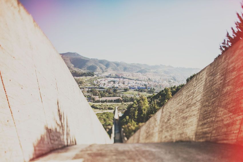 Scenic mountain vista framed between concrete walls on a sunny day.