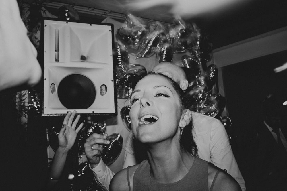 Person enjoying music and dancing with a vintage record player at a party.