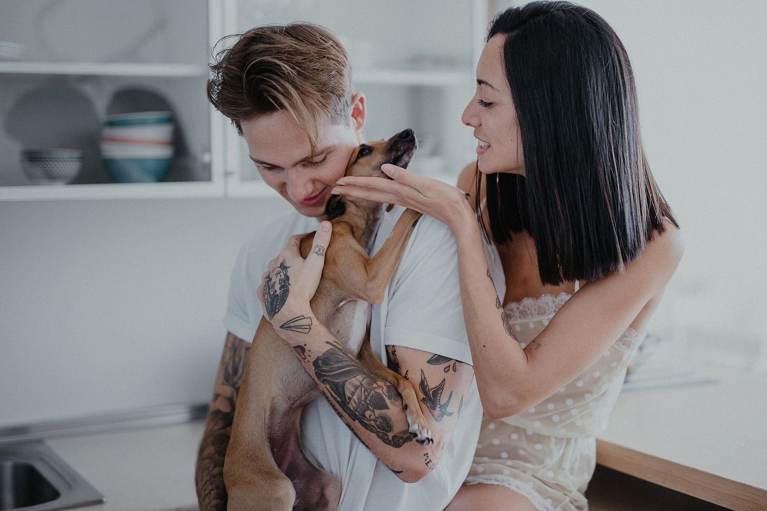 Couple sharing joyful laughter while spending time together in their kitchen.