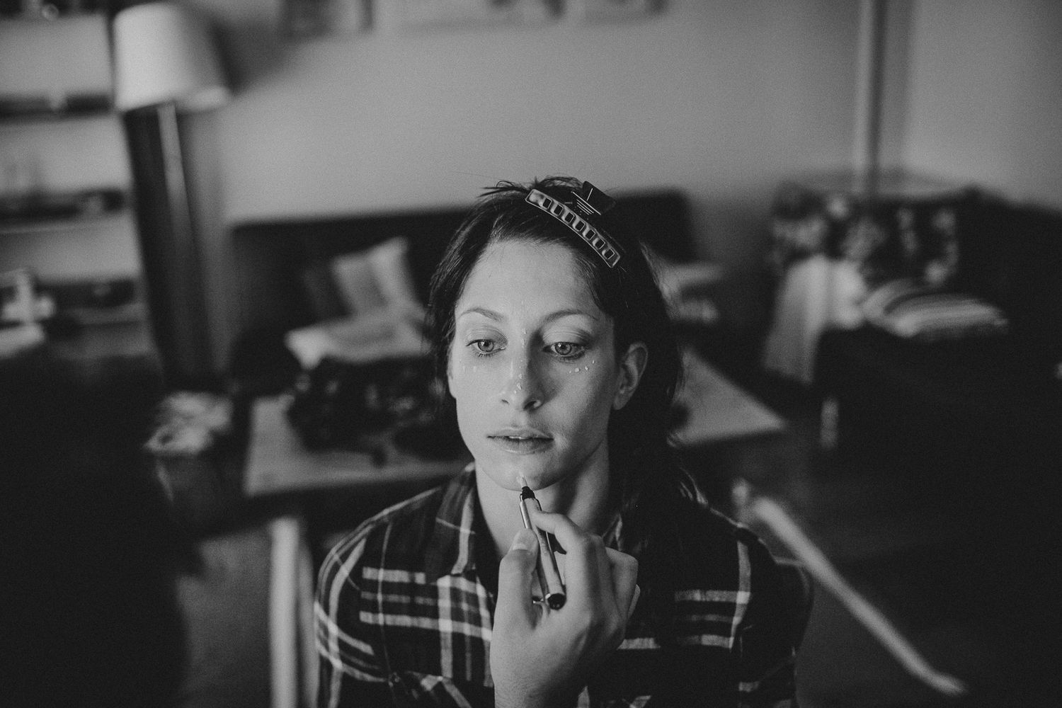 Black and white portrait showing a quiet moment of contemplation in indoor lighting.