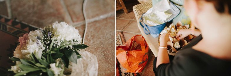 A white floral bouquet sits on a textured surface next to food preparation items.