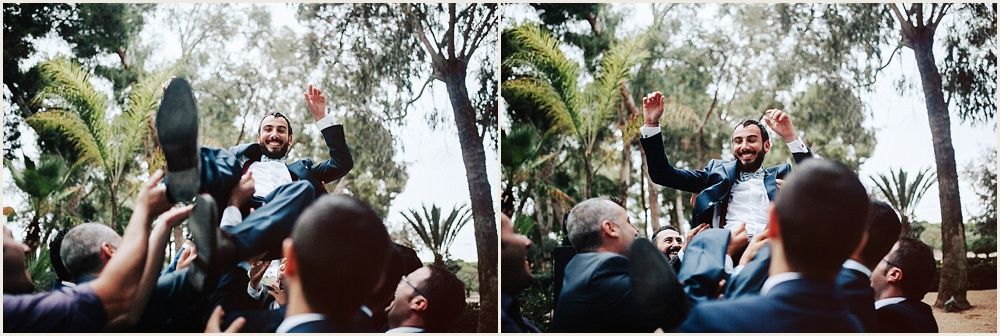 Outdoor wedding celebration scene with guests watching and cheering.