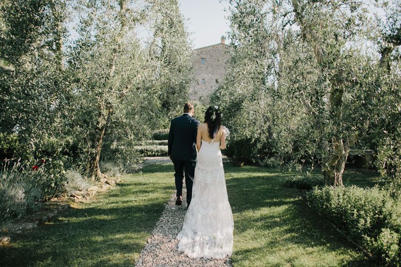 Joyful celebration at an outdoor wedding reception with guests cheering.