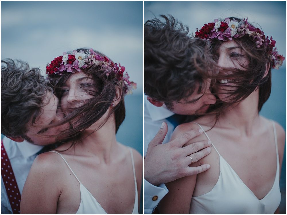 Close-up of couple sharing intimate moment wearing floral crown.