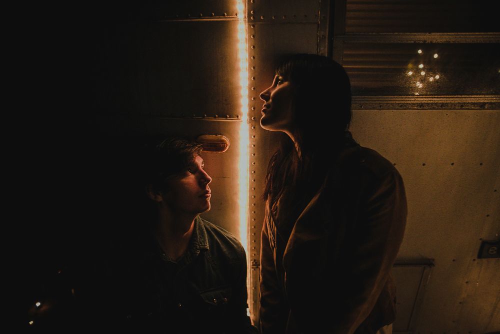 Warm light beam creates atmospheric glow in dark nighttime setting.