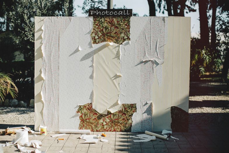 White textured wall installation with decorative signage outdoors.