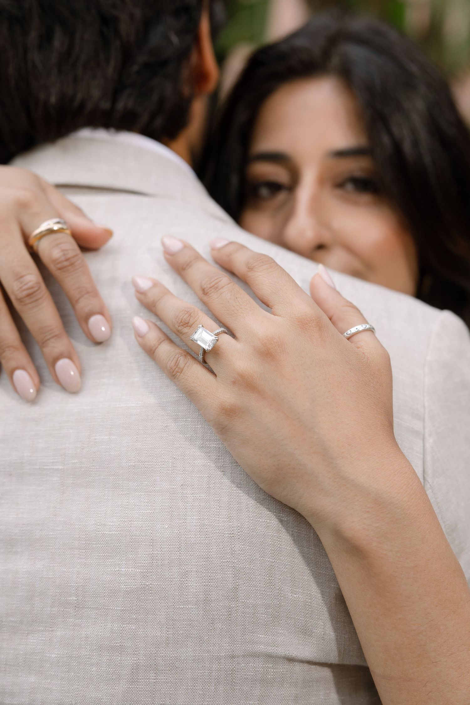 Close view of Elina’s ring and hands resting on Jag’s shoulder.