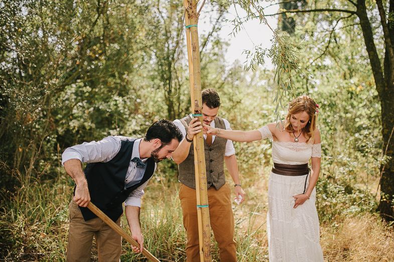 Playful moment during outdoor wedding ceremony with couple and officiant.
