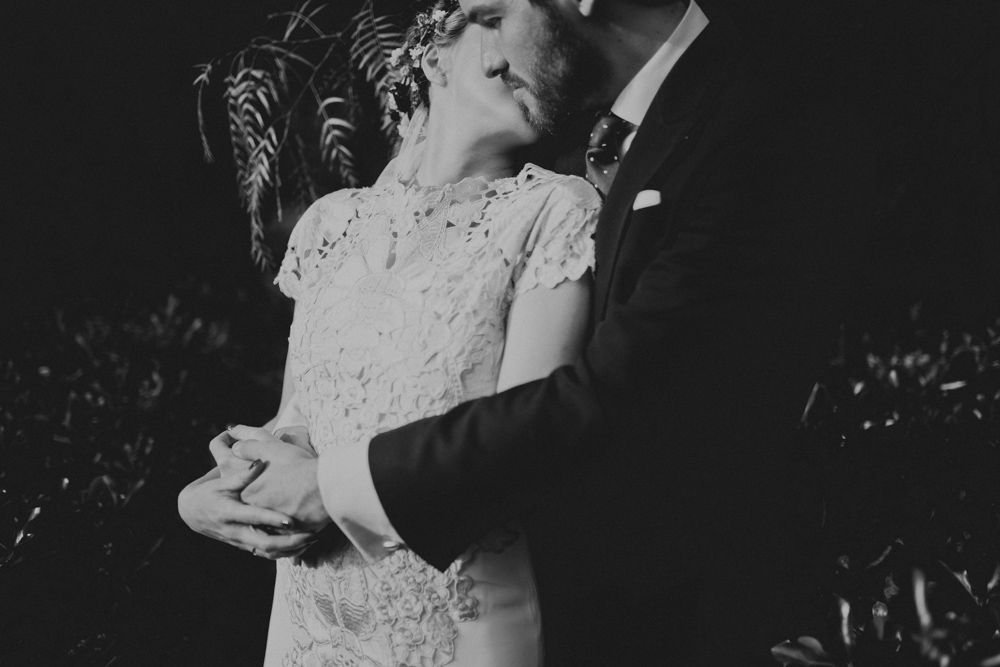 A black and white close-up of a tender wedding dance embrace.
