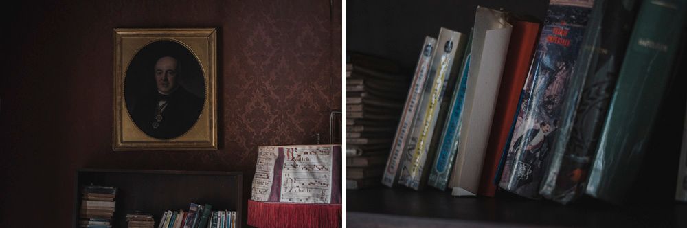 Dark moody still life with vintage books and framed portrait on shelf.
