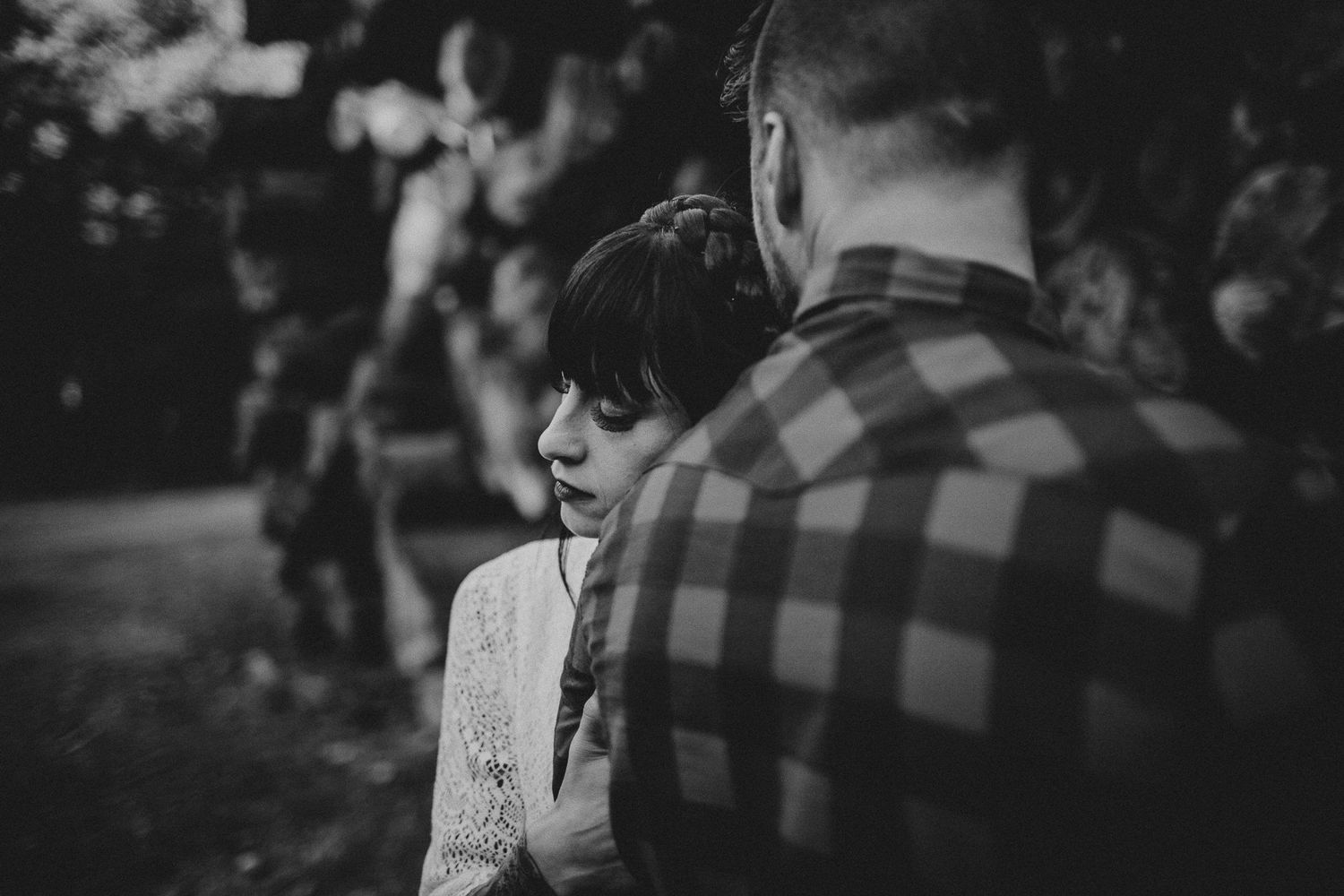 Intimate black and white portrait of a couple in a natural outdoor setting.