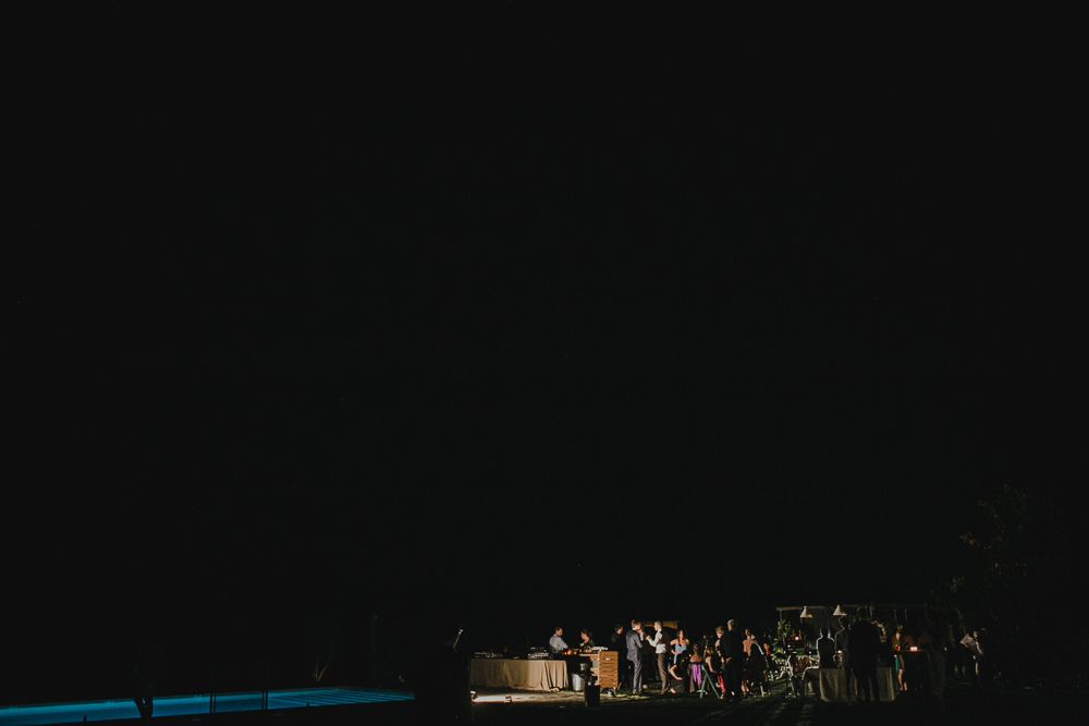 Dark silhouette of a crowd gathered at an outdoor nighttime event.