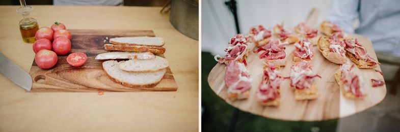 Wedding reception appetizers and charcuterie being prepared on wooden boards.