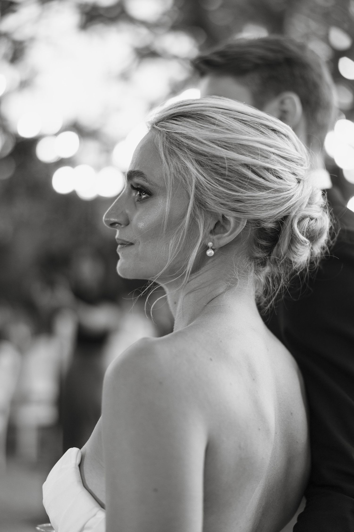 Classic black and white profile portrait with elegant updo hairstyle.