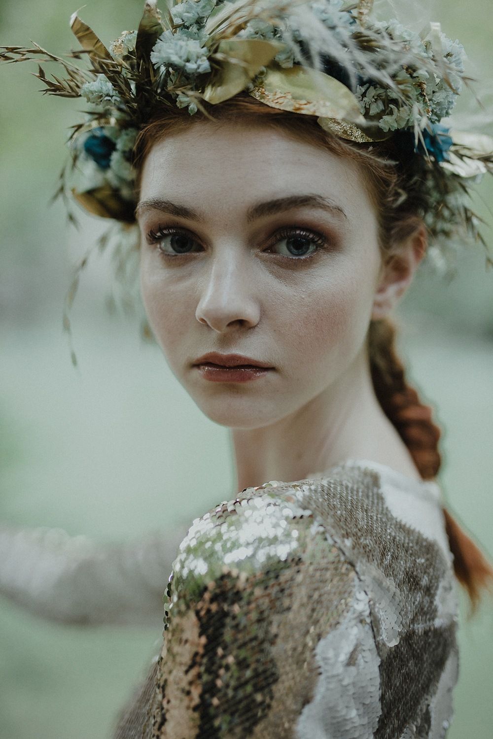 Editorial style portrait with natural crown and sequined dress in ethereal lighting.