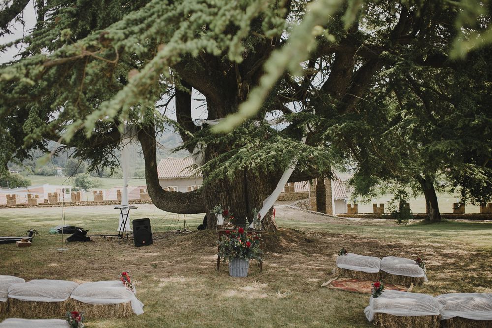 Floor seating arrangement on vintage rug with white cushions in outdoor setting.
