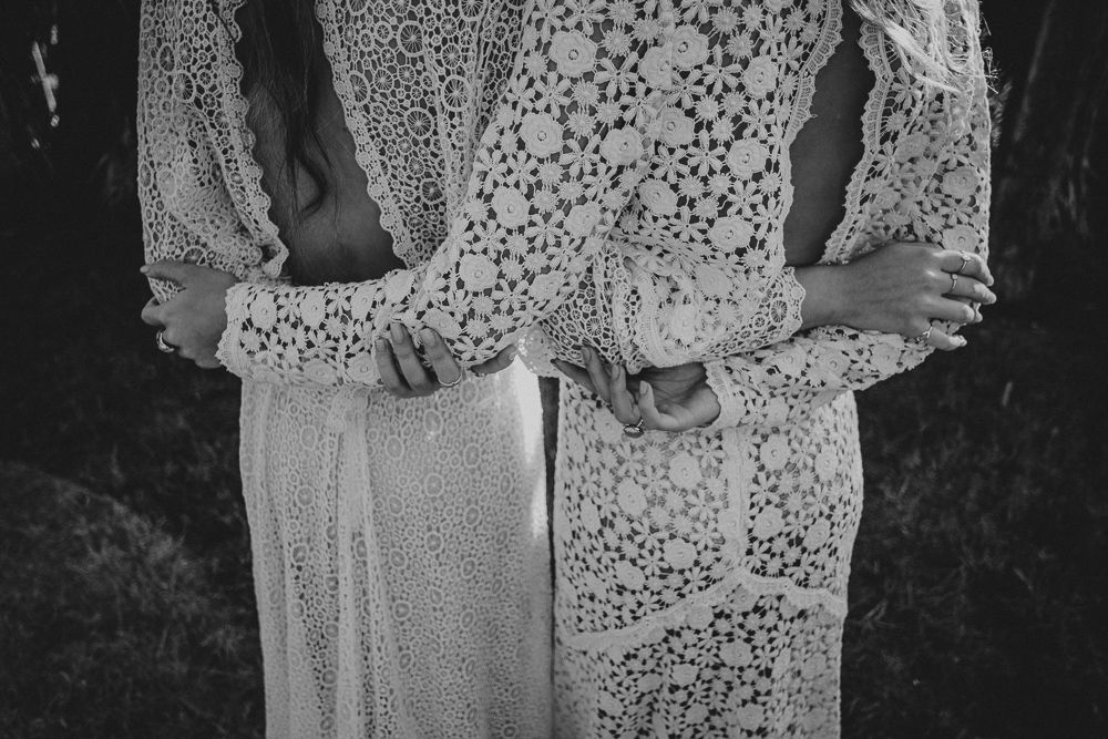Close up detail shot of two lace wedding dresses in black and white.