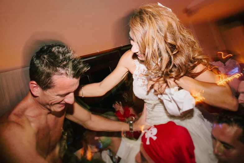 Dynamic party scene with dancing and celebration at a wedding reception.