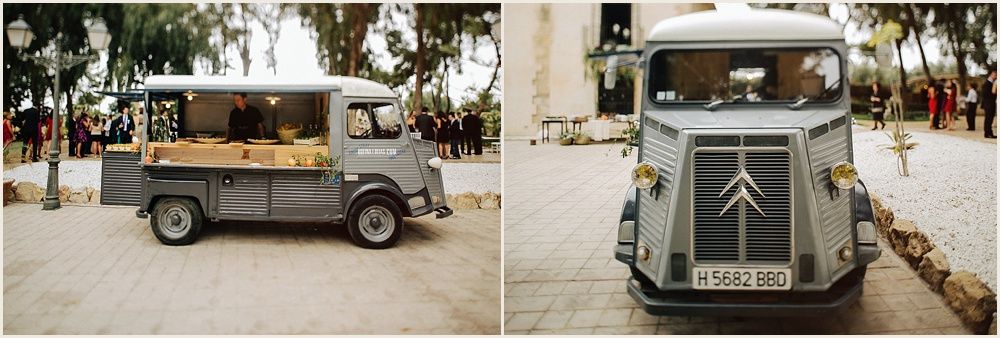 Two classic vintage delivery vans parked on a tree-lined street.