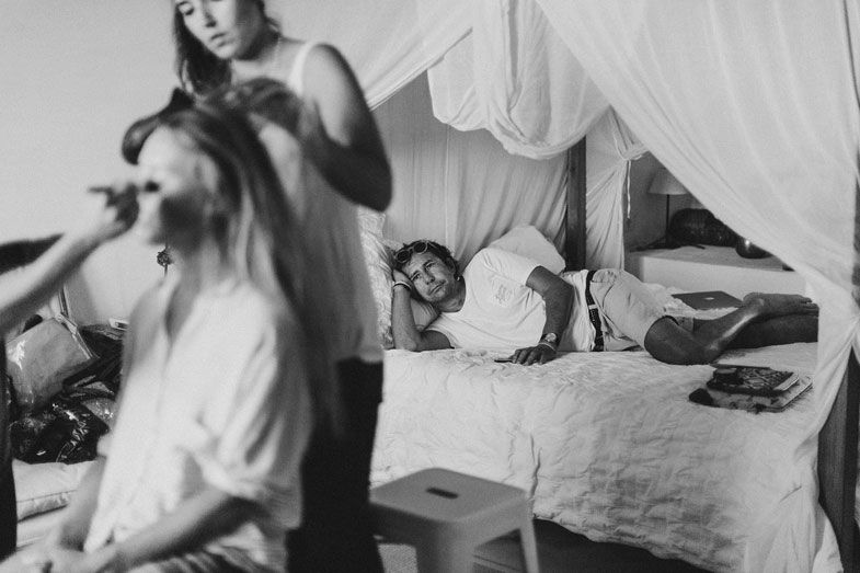 Black and white image of wedding preparation scene with styling in progress.