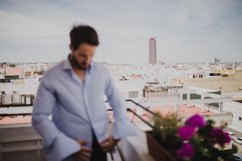 City rooftop view with magenta flowers in foreground on a sunny day.