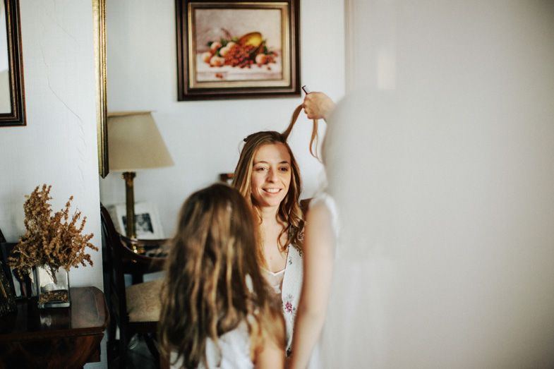 Sunlit getting ready moment during wedding day preparations.