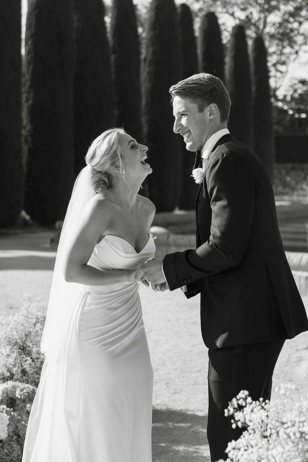 A series of candid black and white wedding photos showing a couple embracing outdoors.