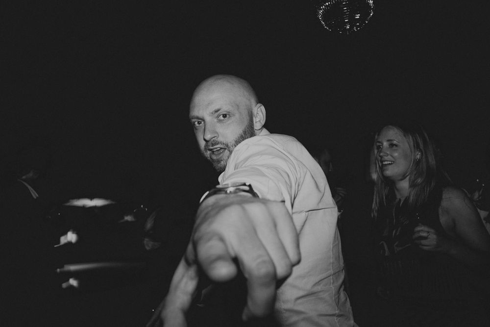 A black and white party scene with dynamic movement and laughter.