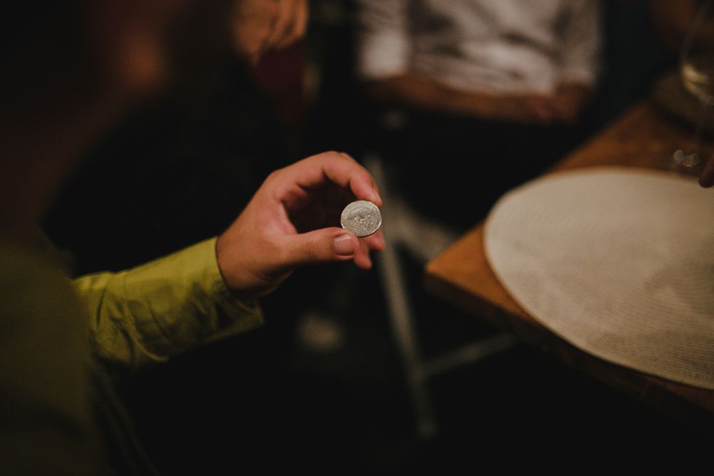 Close-up shot of hand holding a small object at a formal event.