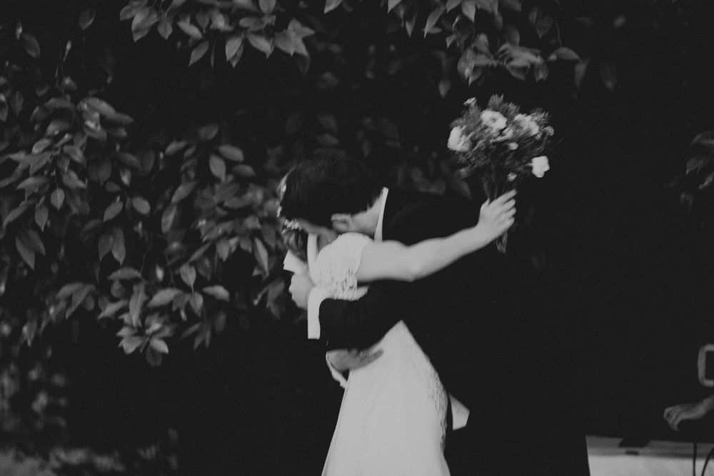 A black and white vintage photograph of a dancing couple in formal attire.