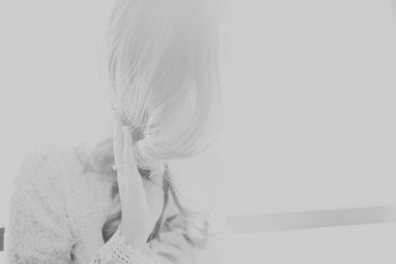 A soft, ethereal black and white portrait showing delicate details in dreamy light.