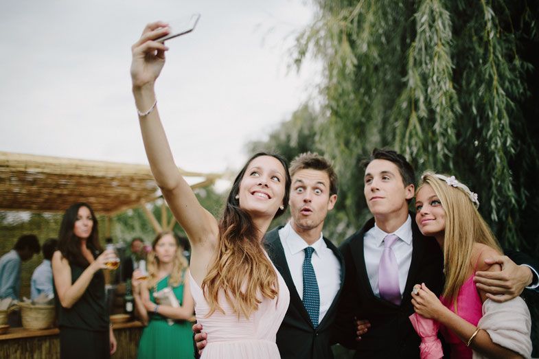 Guests enjoying a lively moment together at an outdoor wedding celebration.