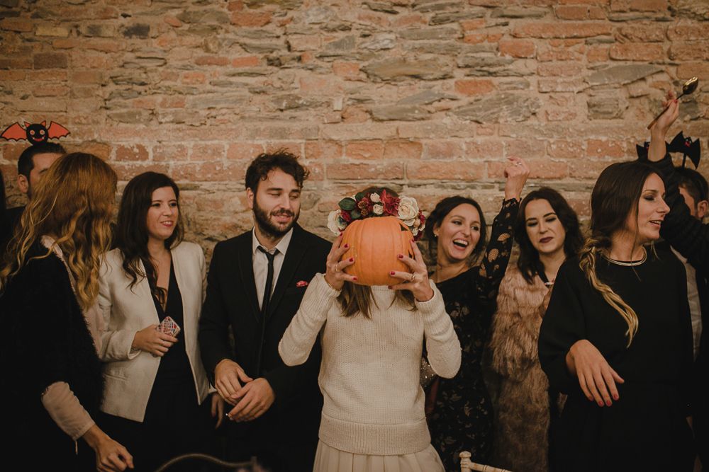 Party guest in white winter hat dances during celebration.