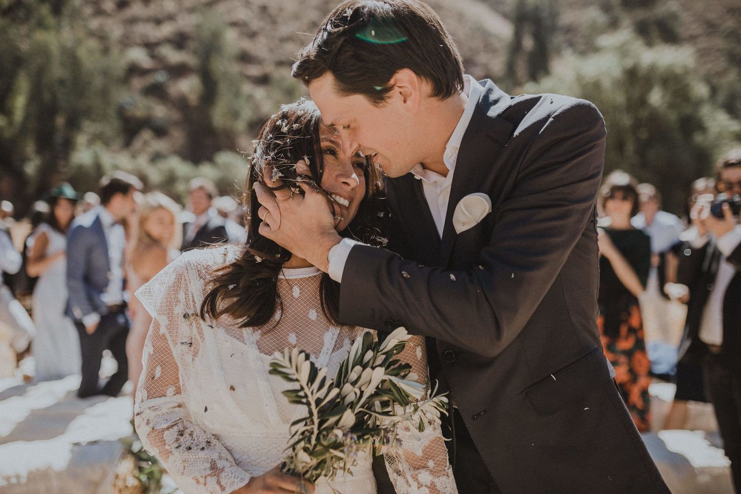 An intimate moment between newlyweds during their rustic outdoor mountain wedding celebration.